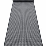 Busk Black wool runner rug rolled up on a white background