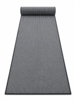Busk Black wool runner rug rolled up on a white background