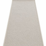 Sandstone wool runner rug rolled up on a white background