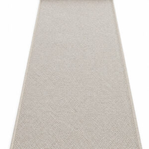 Sandstone wool runner rug rolled up on a white background