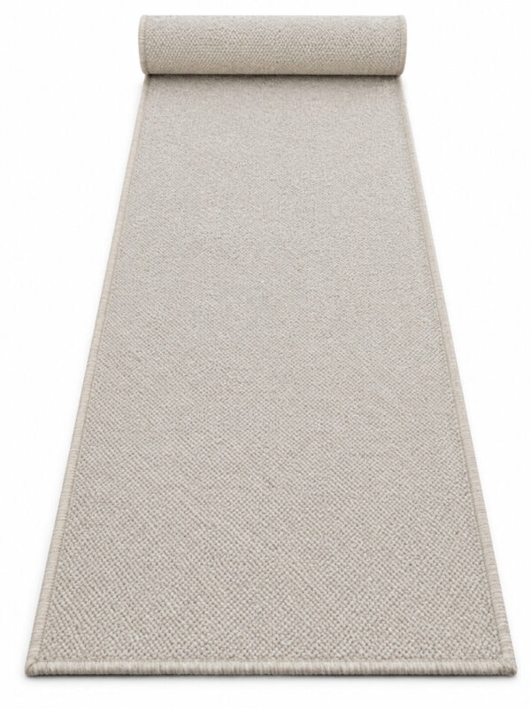 Sandstone wool runner rug rolled up on a white background