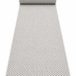 Wool Twill wool runner rug rolled up on a white background