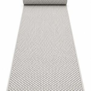 Wool Twill wool runner rug rolled up on a white background